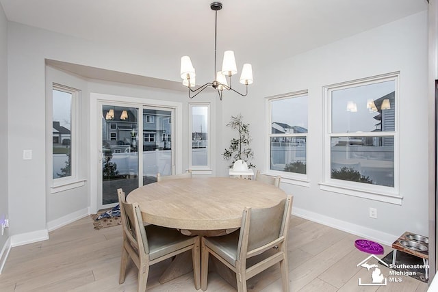 dining room featuring a notable chandelier and light hardwood / wood-style floors