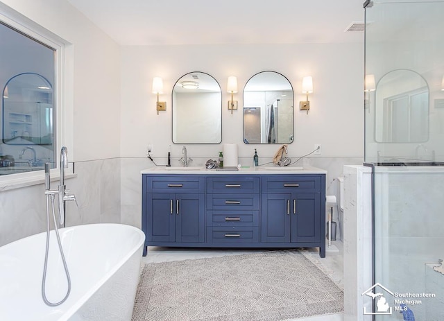 bathroom with vanity, tile walls, and plus walk in shower