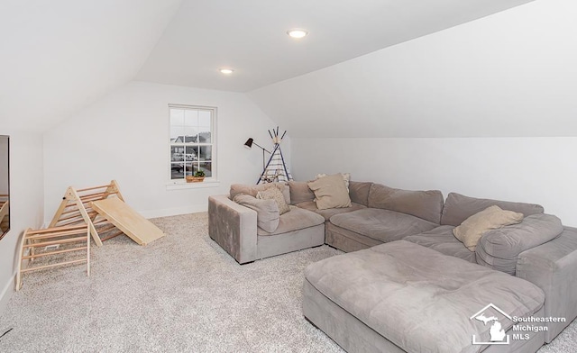 living room with vaulted ceiling and light colored carpet