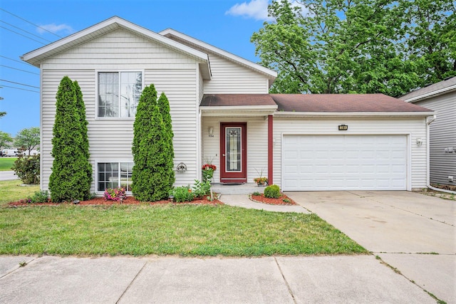 tri-level home with a garage and a front yard