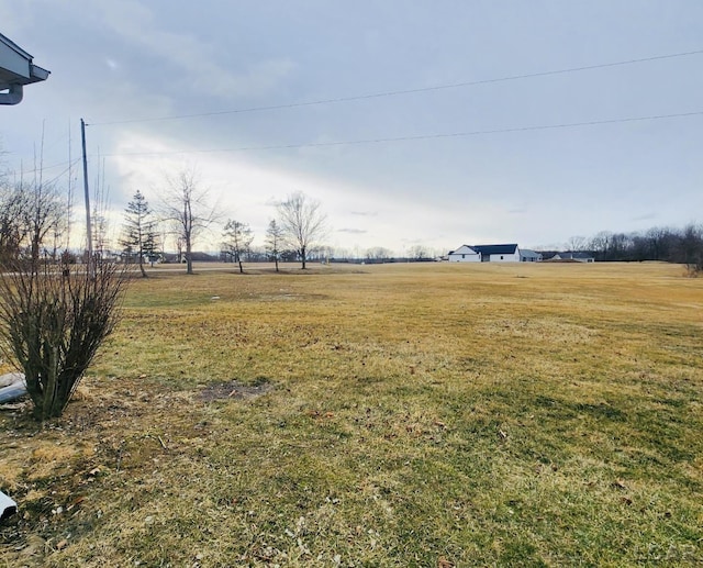 view of yard with a rural view