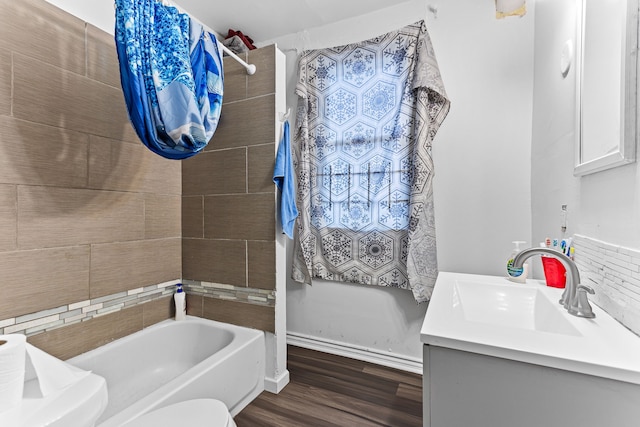 full bathroom with vanity, tiled shower / bath, hardwood / wood-style flooring, and toilet