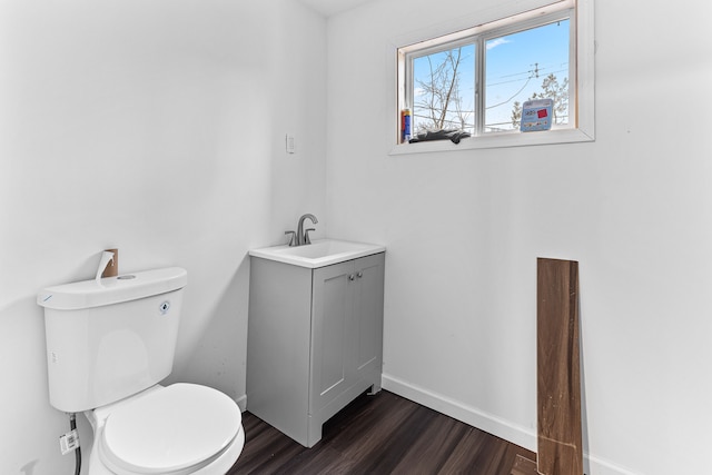 bathroom with hardwood / wood-style flooring, vanity, and toilet