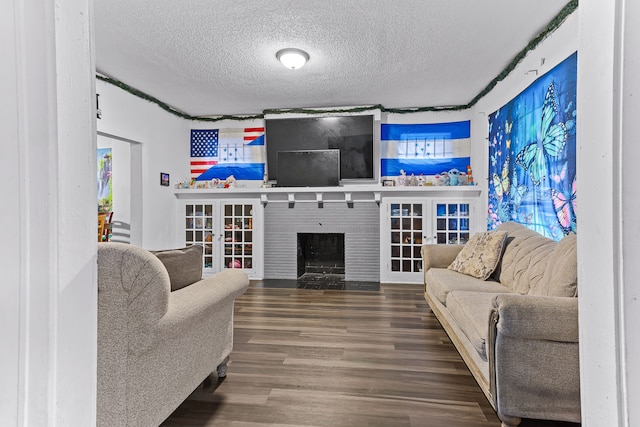 living room with hardwood / wood-style floors and a textured ceiling