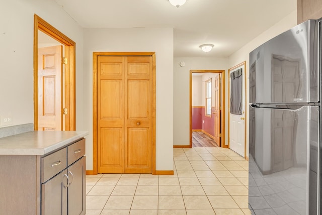 kitchen featuring stainless steel refrigerator and light tile patterned floors