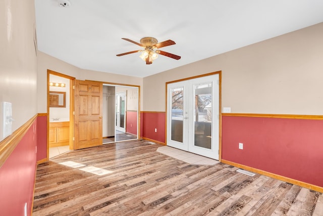 unfurnished room featuring light hardwood / wood-style floors, french doors, and ceiling fan