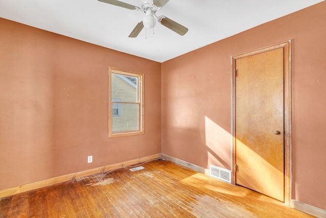 empty room with hardwood / wood-style flooring and ceiling fan