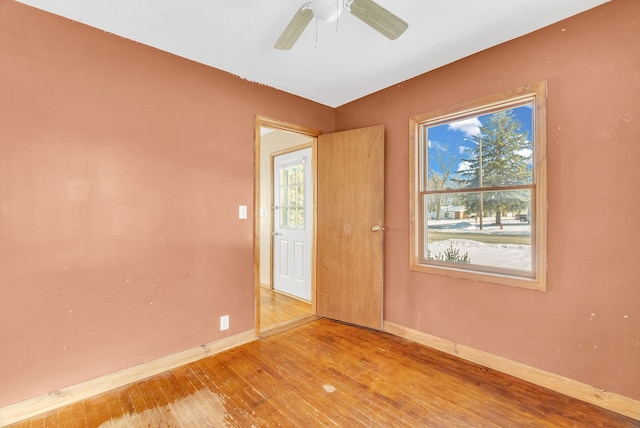 unfurnished room with ceiling fan and wood-type flooring