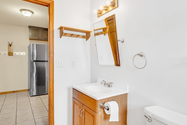 bathroom with vanity, tile patterned floors, and toilet