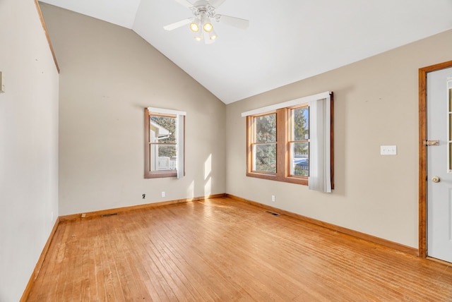 unfurnished room with ceiling fan, lofted ceiling, and light wood-type flooring