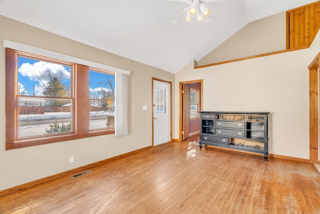 unfurnished living room featuring high vaulted ceiling and hardwood / wood-style floors