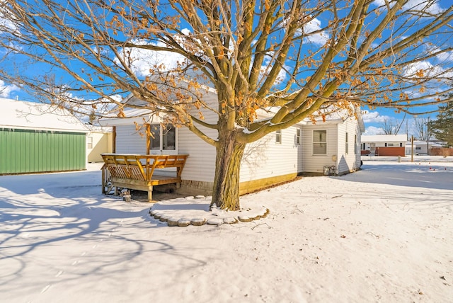 view of snow covered rear of property