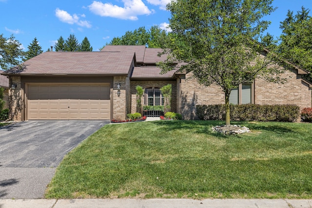 view of front of home with a garage and a front yard