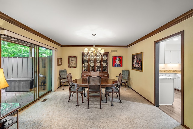 dining area featuring ornamental molding, light carpet, and a notable chandelier