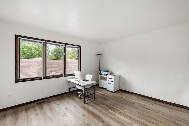 unfurnished office featuring light hardwood / wood-style flooring