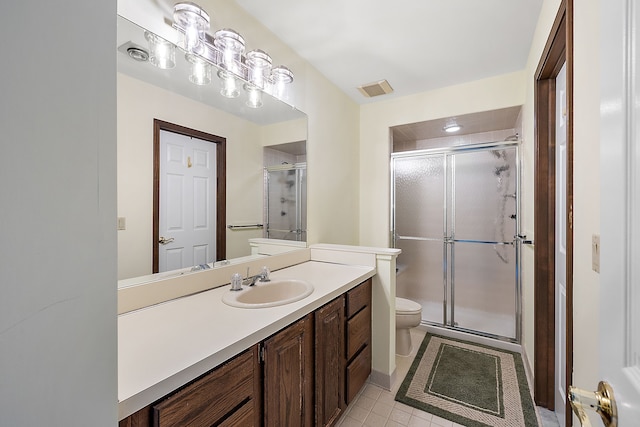 bathroom with vanity, toilet, and walk in shower