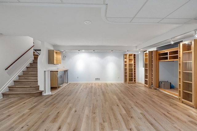 unfurnished living room with track lighting and light hardwood / wood-style floors