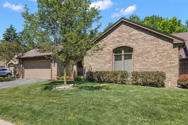 view of front of property featuring a garage and a front lawn