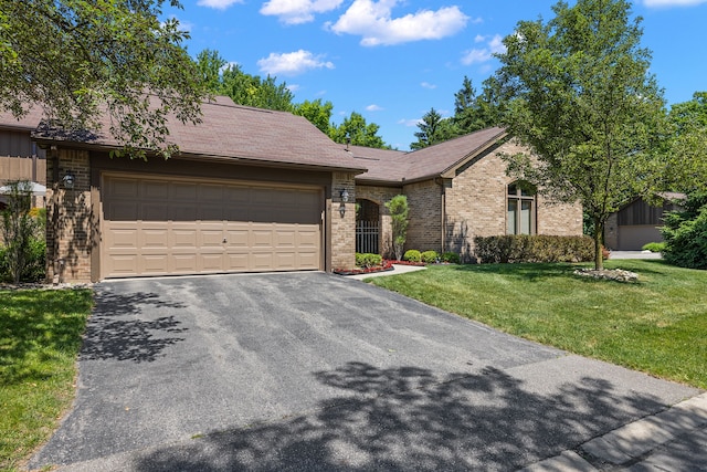 ranch-style home featuring a garage and a front lawn