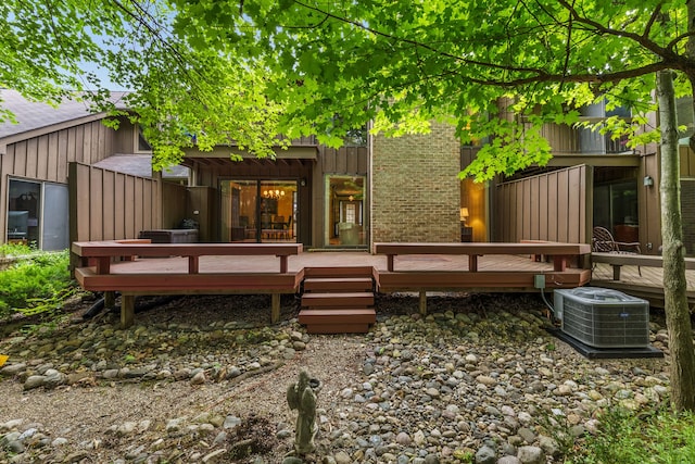 back of house featuring a wooden deck and central AC unit