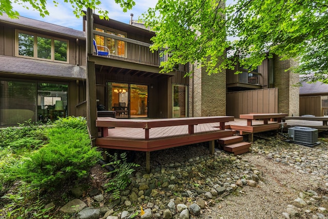 rear view of house with a wooden deck and central AC