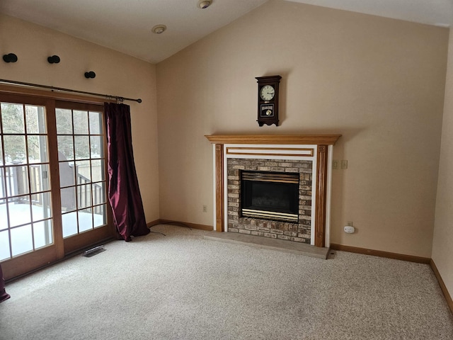 unfurnished living room with lofted ceiling, carpet floors, and a fireplace