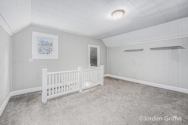 bonus room with vaulted ceiling and carpet