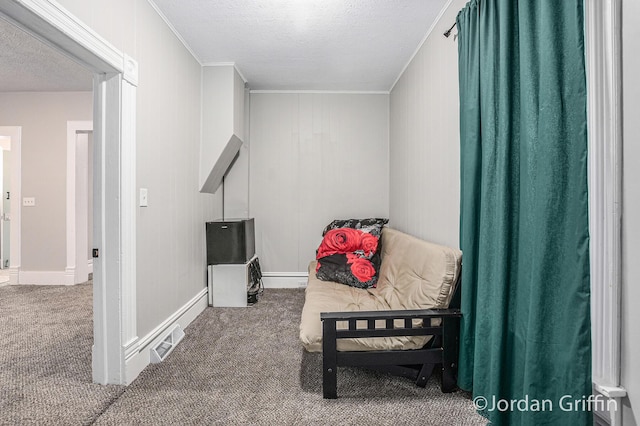 bedroom with crown molding, a textured ceiling, and carpet