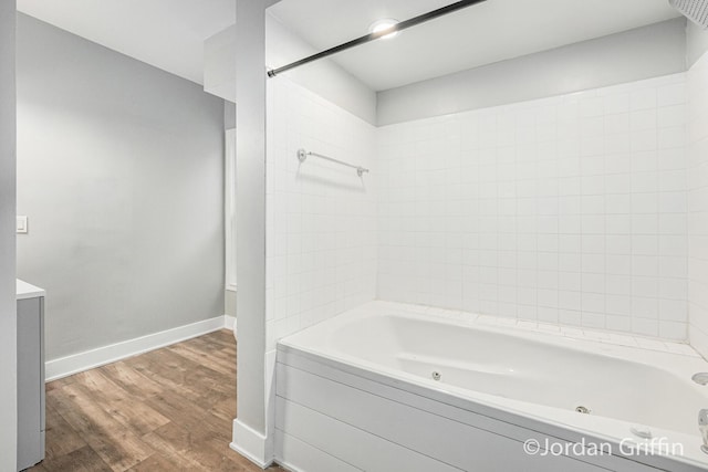 bathroom featuring tiled shower / bath combo and hardwood / wood-style floors