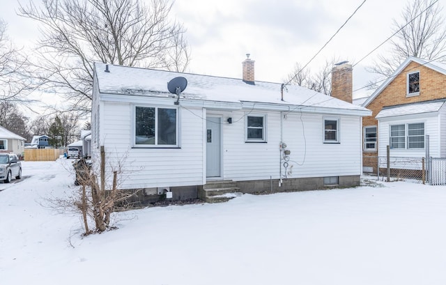 view of snow covered rear of property