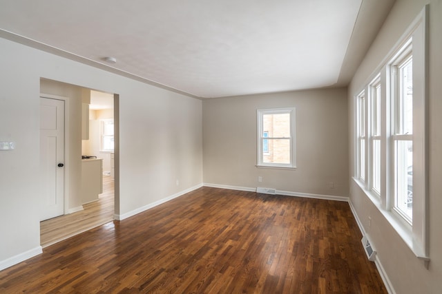 unfurnished room with dark wood-type flooring