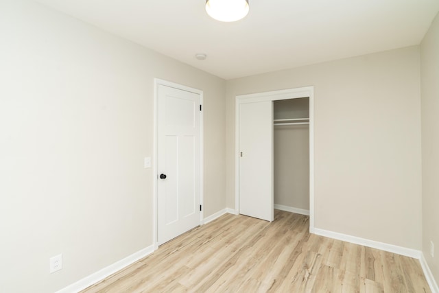 unfurnished bedroom featuring a closet and light hardwood / wood-style flooring