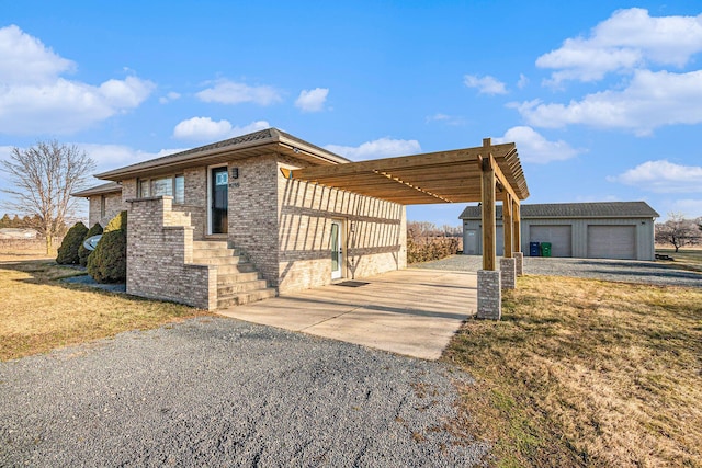 view of side of property with a garage, a yard, and a carport