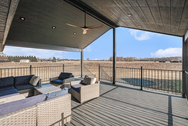 deck featuring outdoor lounge area, a rural view, and ceiling fan