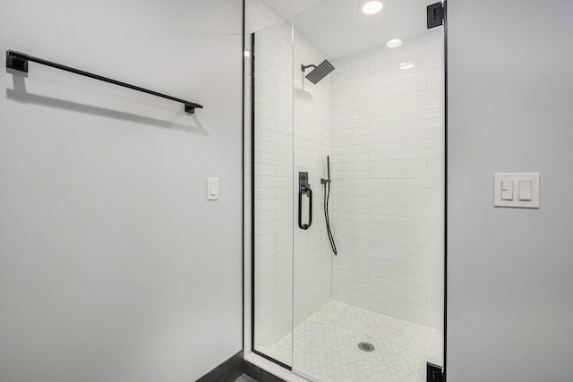 bathroom featuring a shower with shower door