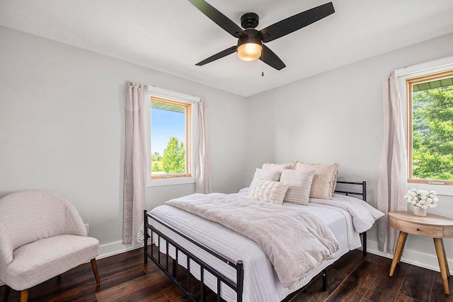 bedroom with dark hardwood / wood-style floors and ceiling fan