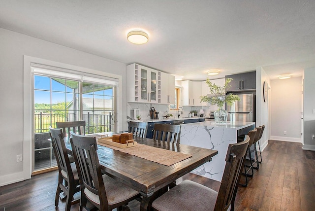 dining space featuring dark hardwood / wood-style flooring and sink