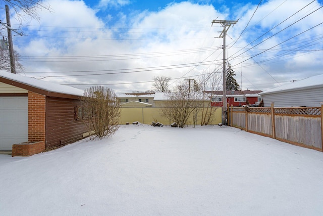 view of yard layered in snow