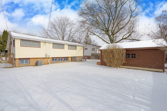 snow covered property featuring central AC