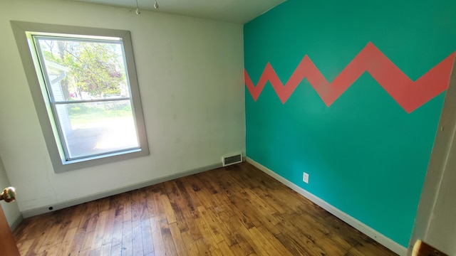 930 W Barney Ave, Muskegon, MI 49441 - empty room with hardwood / wood-style flooring and baseboards