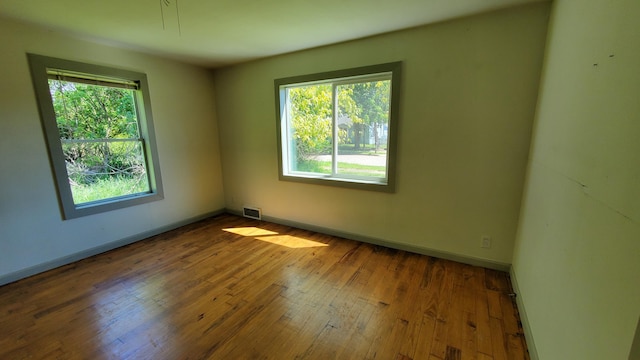 930 W Barney Ave, Muskegon, MI 49441 - empty room with hardwood / wood-style flooring and baseboards