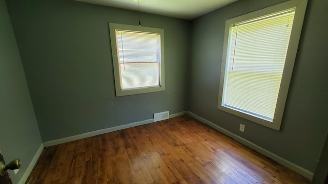 930 W Barney Ave, Muskegon, MI 49441 - spare room featuring hardwood / wood-style floors