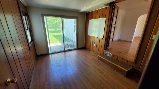 930 W Barney Ave, Muskegon, MI 49441 - empty room with arched walkways and wood finished floors