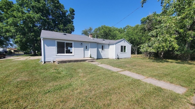 930 W Barney Ave, Muskegon, MI 49441 - view of front of house featuring a front lawn and a chimney