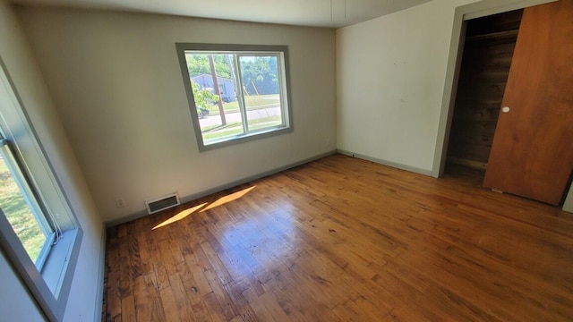 930 W Barney Ave, Muskegon, MI 49441 - unfurnished bedroom with wood finished floors and baseboards