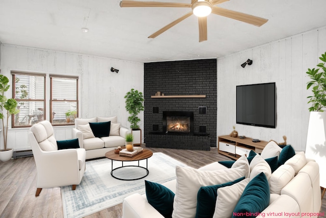 living room with a fireplace, hardwood / wood-style flooring, a baseboard radiator, and ceiling fan