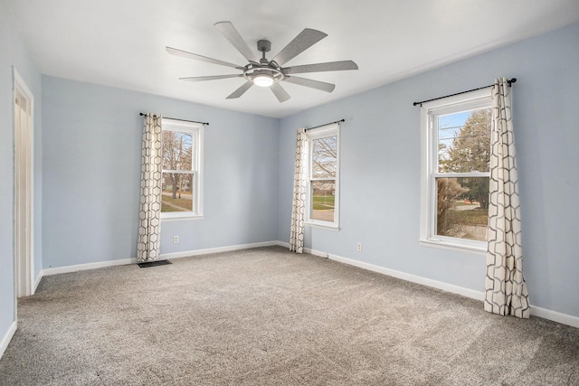 carpeted spare room featuring ceiling fan