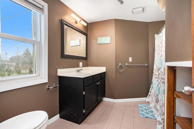 bathroom featuring tile patterned floors, vanity, and toilet