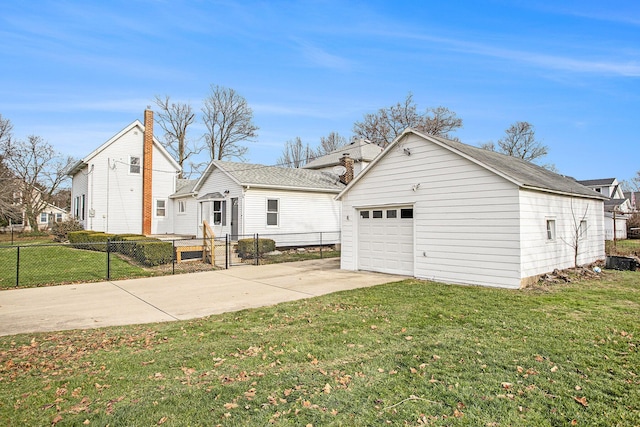 exterior space with a garage, an outdoor structure, and a yard