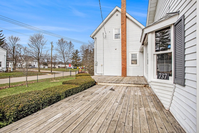 wooden terrace featuring a yard